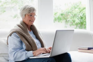 smiling older woman using laptop 2022 03 07 23 57 01 utc